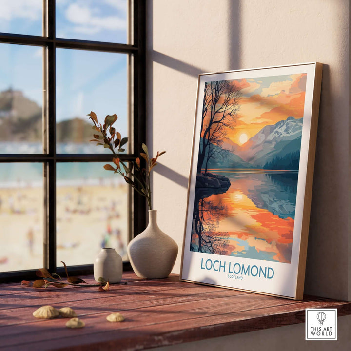 Loch Lomond poster displayed on a windowsill, showcasing beautiful Scottish landscape with mountains and sunset colors.