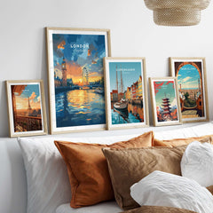 London Skyline Poster | Sunset Cityscape Wall Art Print displayed among other cityscape art prints on a stylish sofa.