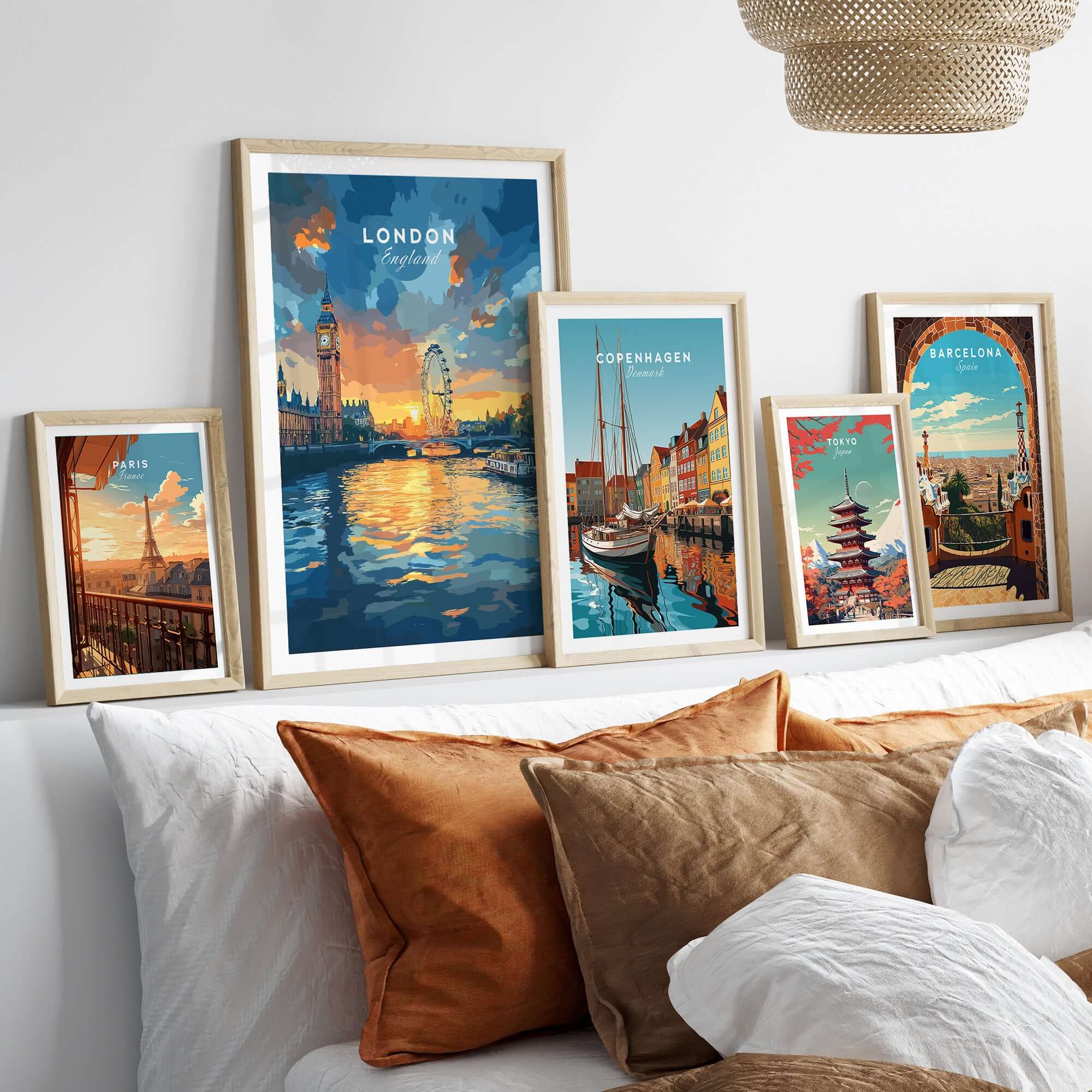 London Skyline Poster | Sunset Cityscape Wall Art Print displayed among other cityscape art prints on a stylish sofa.