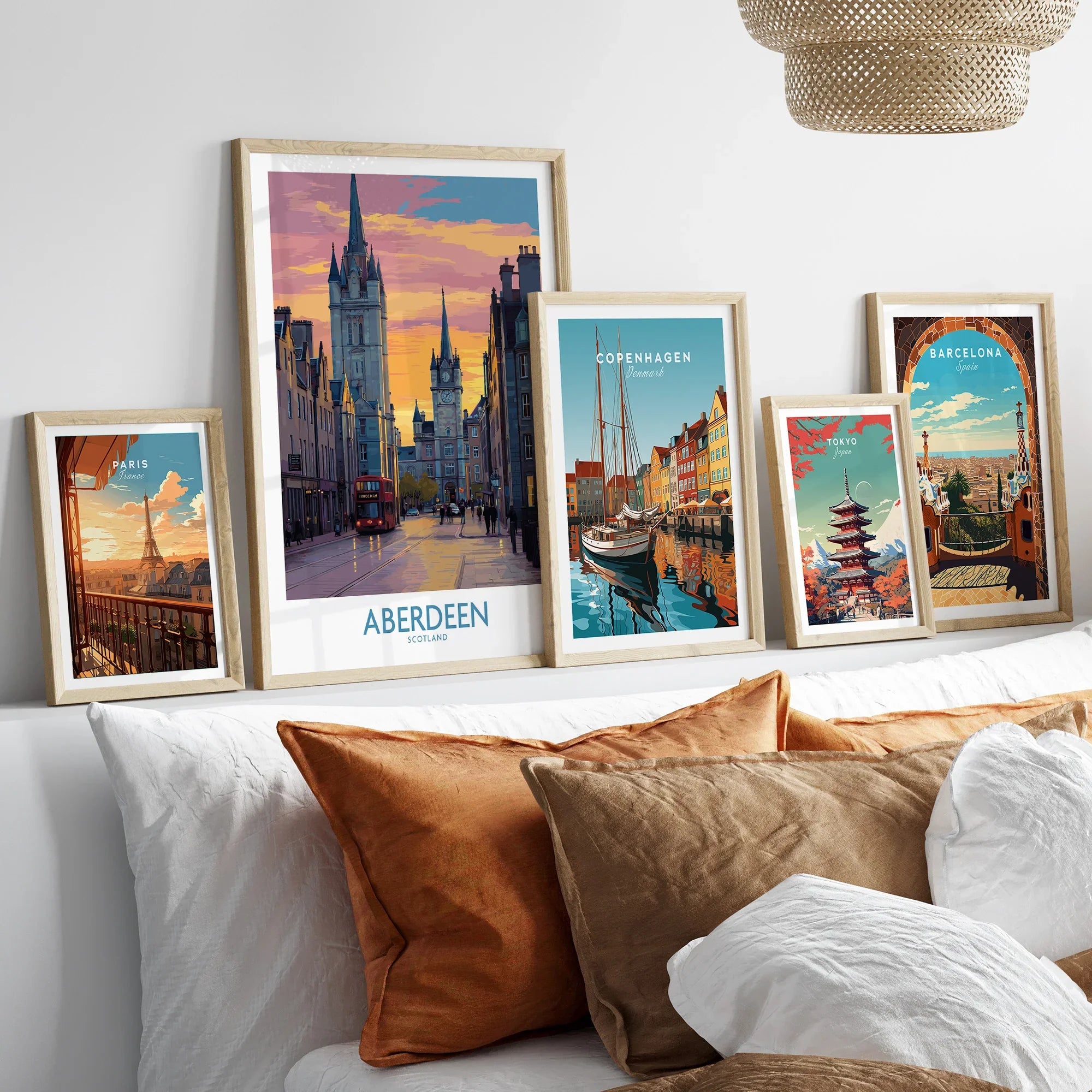 Framed travel posters of Paris, Aberdeen, Copenhagen, Tokyo, and Barcelona for wall art decor