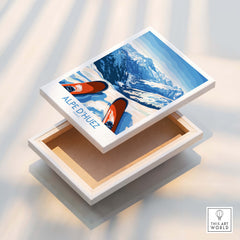 Alpe d'Huez Art Print Winter Sports displayed on a wooden box with mountain scenery and skiing elements.