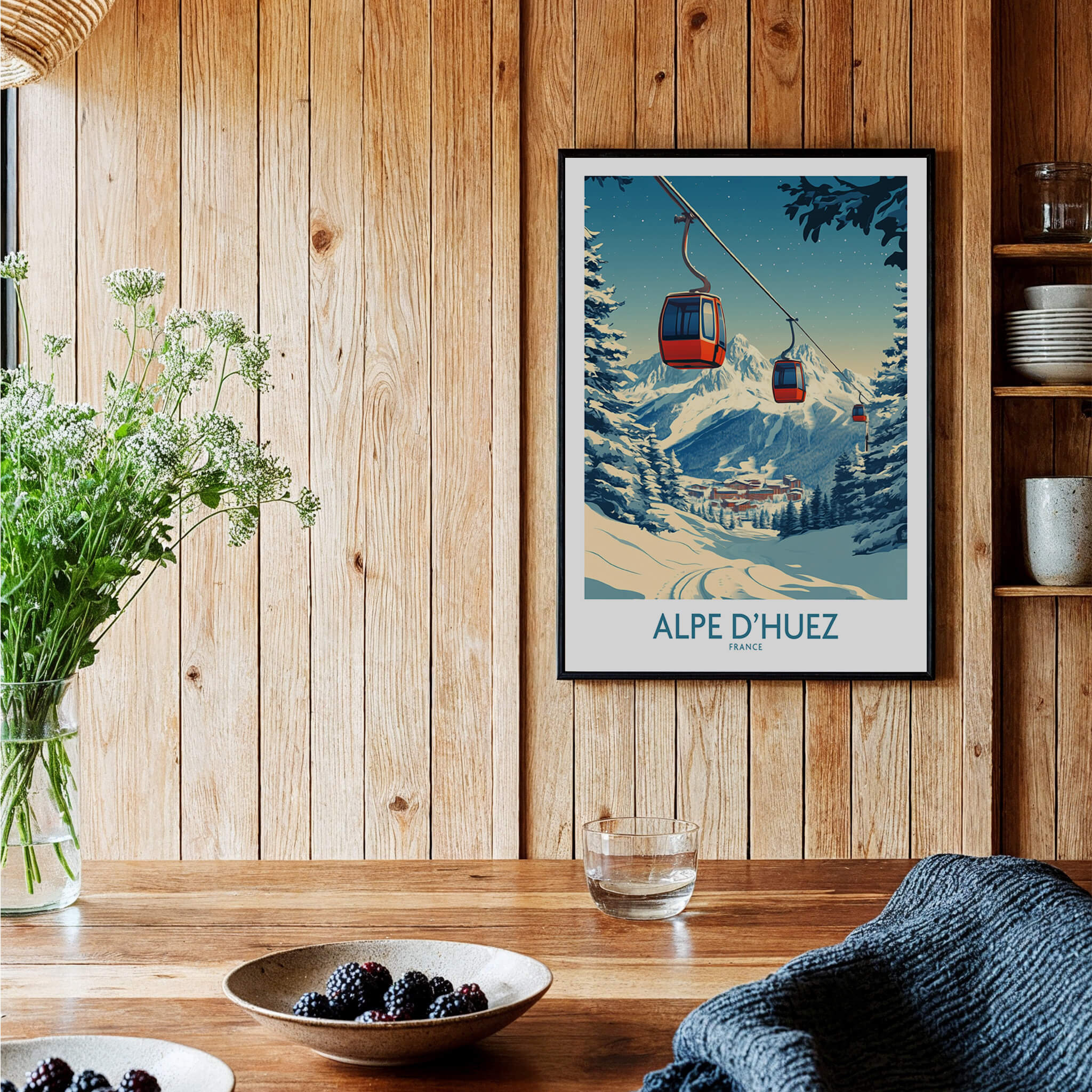 Alpe d'Huez Poster France displayed in a cozy interior setting with a wooden backdrop and decorative elements.