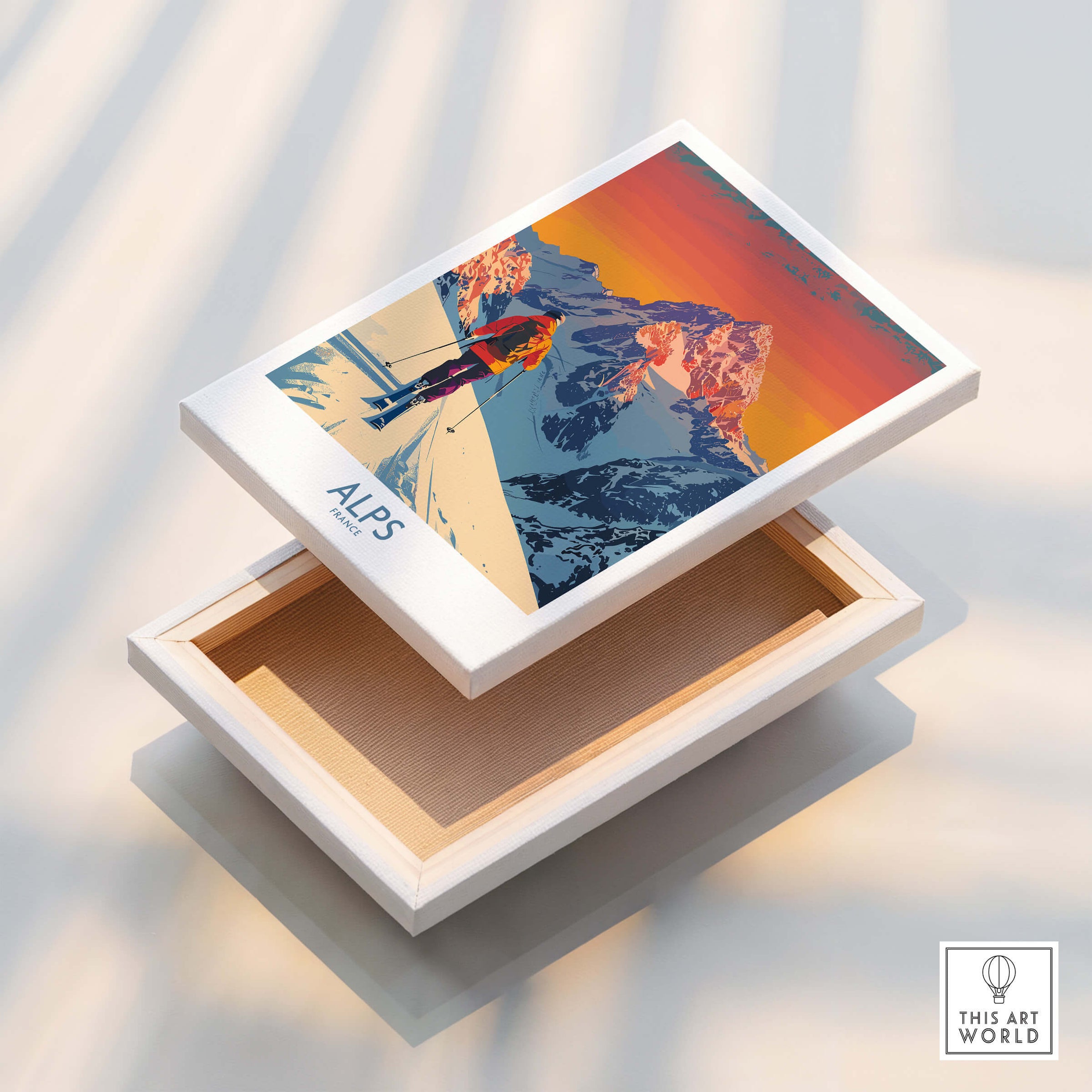 Alps Poster France displayed on a white box, featuring vibrant colors of snowy mountains and a skier.