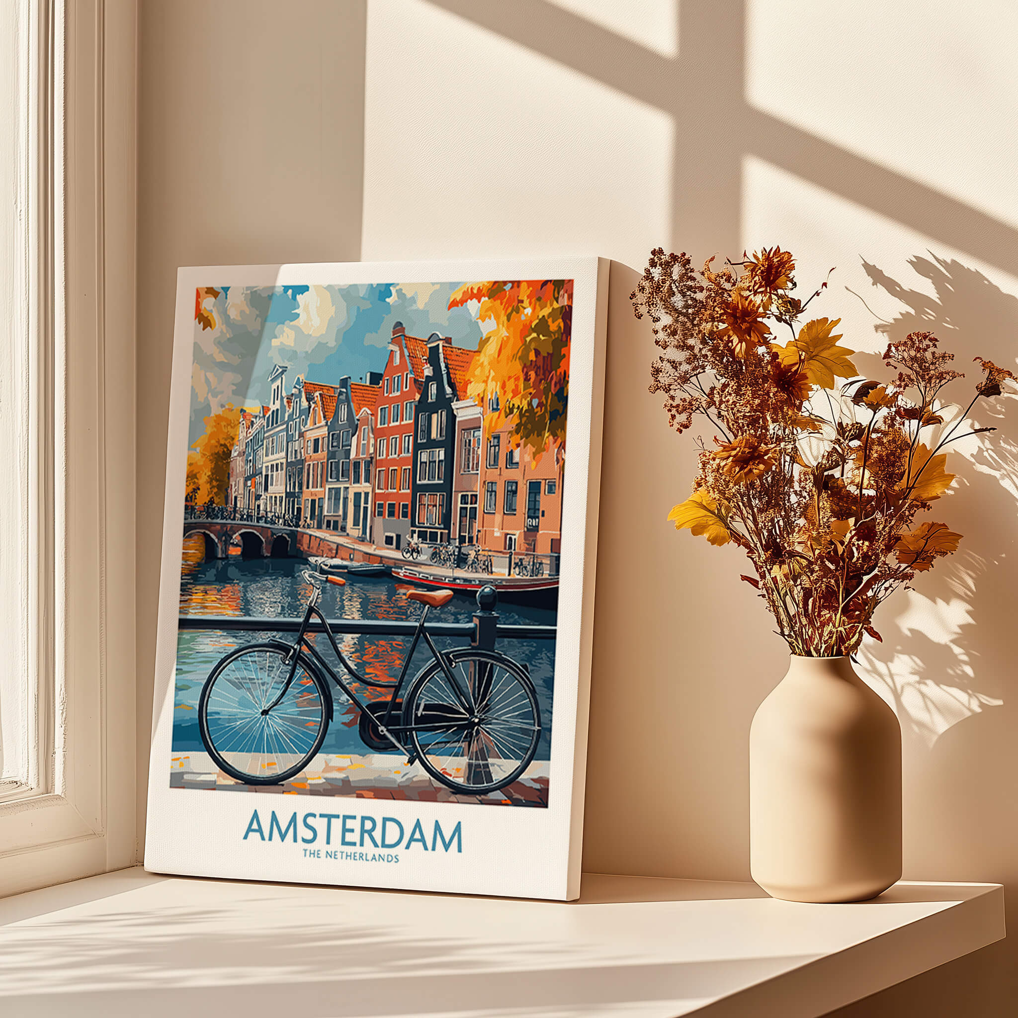 Bright Amsterdam Canal Poster - Colourful Dutch Houses Reflecting on Water Art displayed beside a vase with flowers.