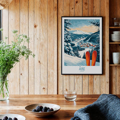 Åre Sweden Ski Poster displayed in a cozy interior with wooden walls, featuring skis and a scenic mountain view.