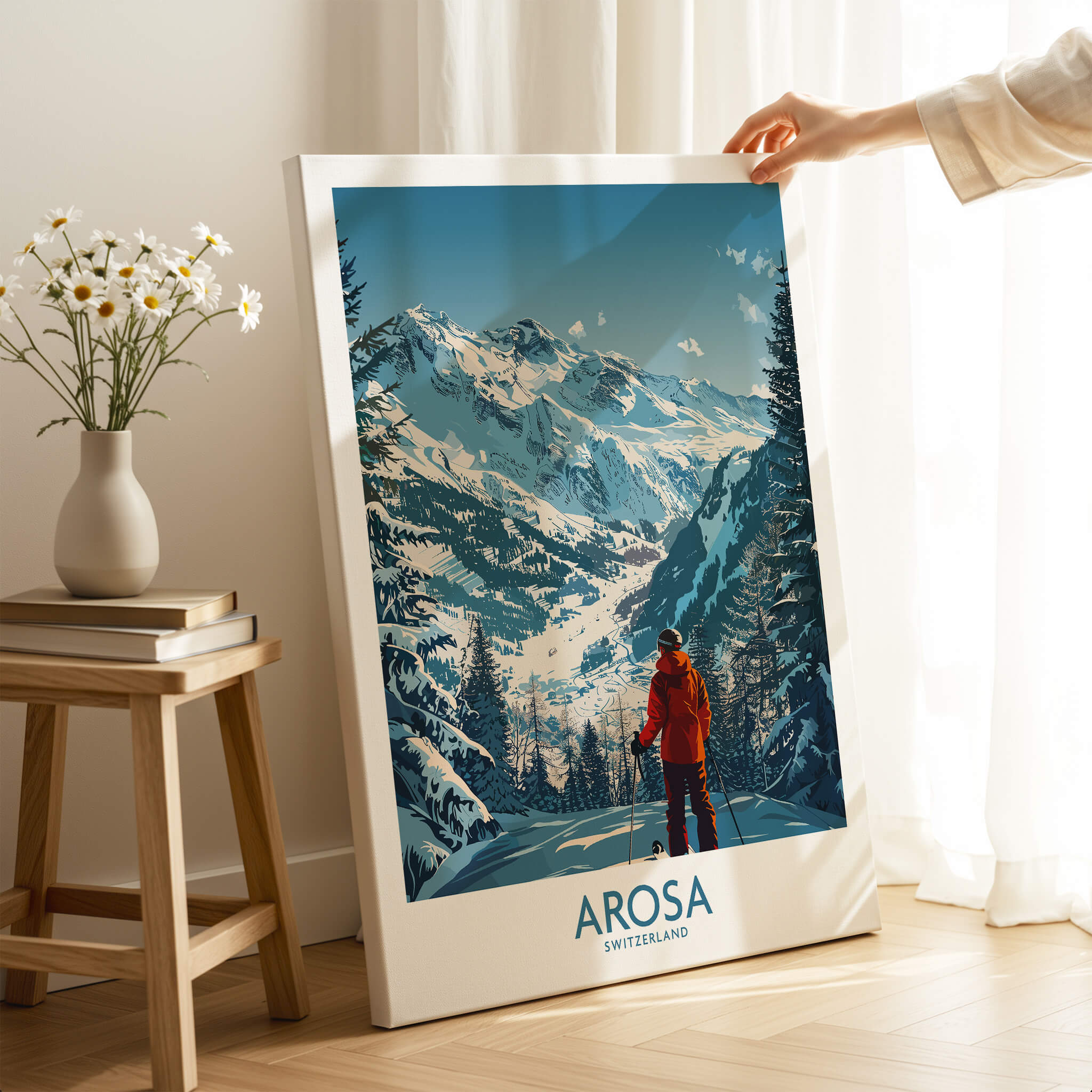 Arosa Wall Art Print Switzerland displayed indoors, showcasing snowy mountains and a skier in a red jacket.