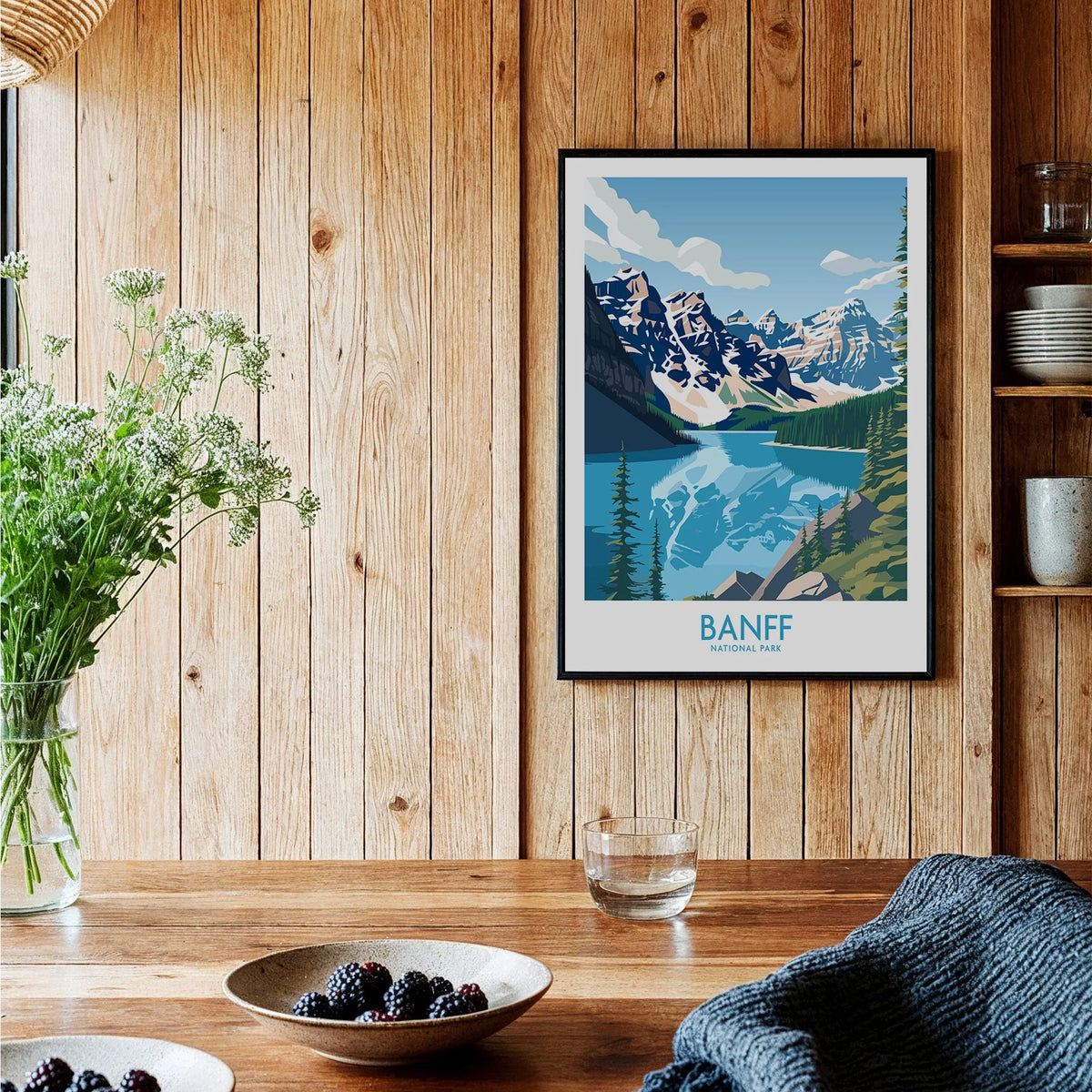 Banff National Park art print with mountain and lake scene, framed on wooden kitchen wall