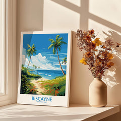 Biscayne National Park travel poster print with palm trees, on windowsill beside vase of dried flowers