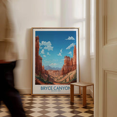 Framed Bryce Canyon National Park art print on floor beside a wooden stool, man walking past.