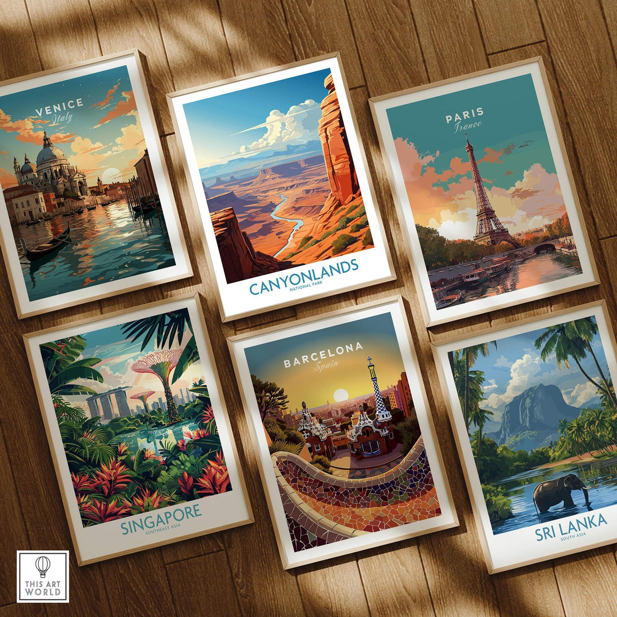 Set of six framed travel posters featuring Venice, Canyonlands, Paris, Singapore, Barcelona, and Sri Lanka on a wooden floor.