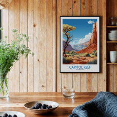 Framed Capitol Reef National Park art print hanging in rustic kitchen with wooden walls.