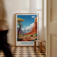 Framed Capitol Reef National Park art print on floor in bright hallway, man walking past