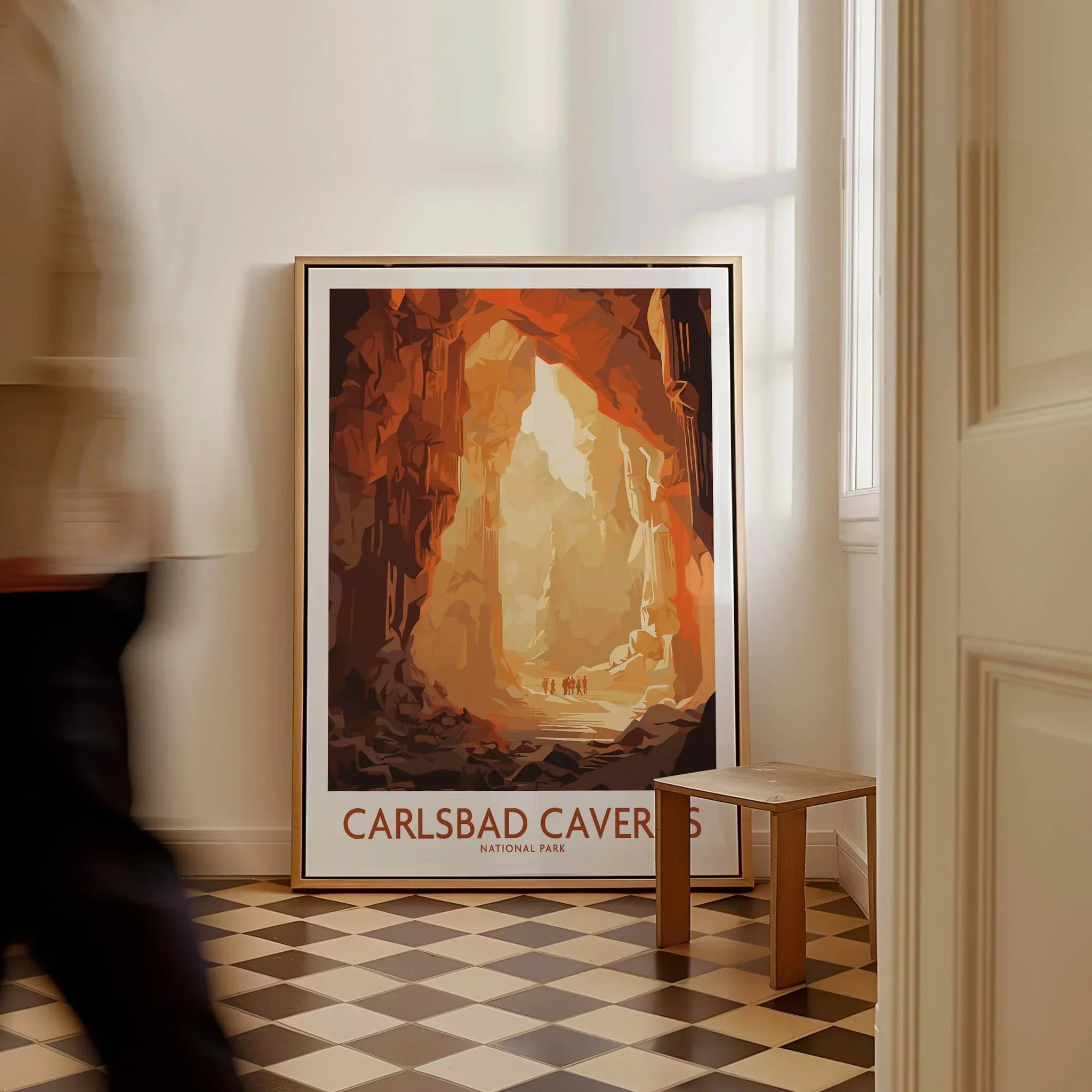 Framed Carlsbad Caverns National Park travel poster on floor in modern home interior