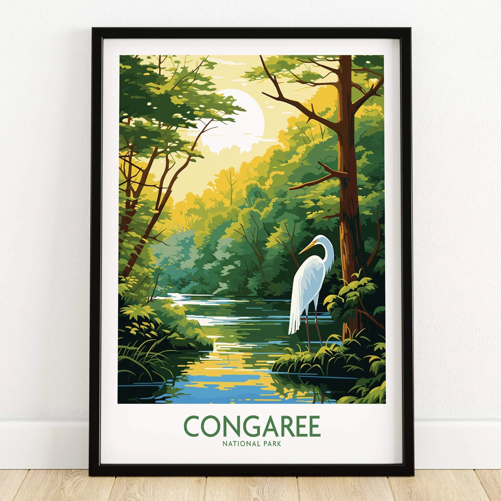 Framed Congaree National Park art print with river, trees, and white heron on wooden floor