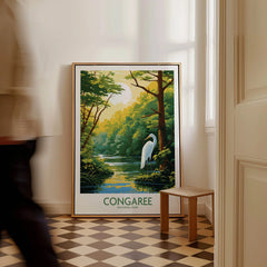 Framed Congaree National Park poster with heron, propped on floor in bright hallway