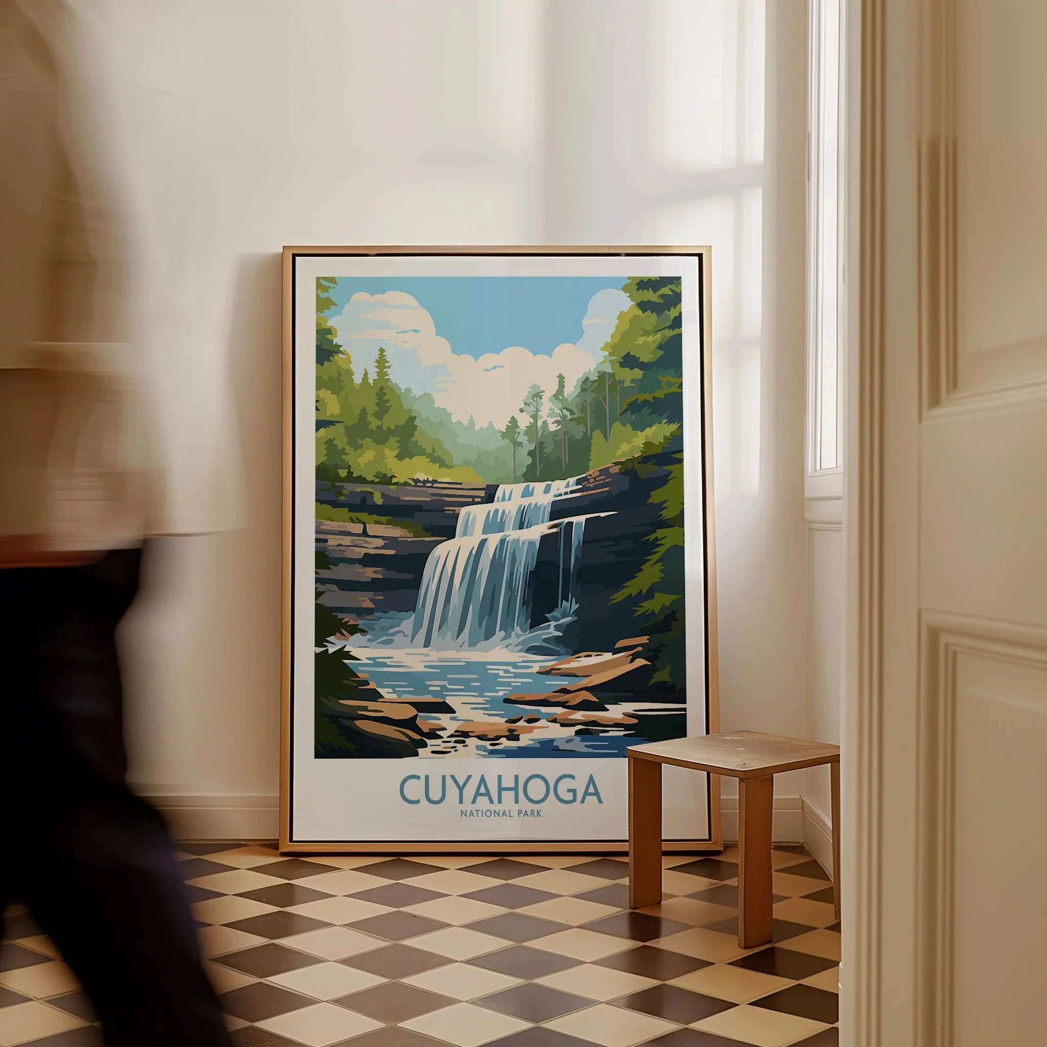Framed Cuyahoga National Park waterfall art print on floor in bright entryway, man walking past