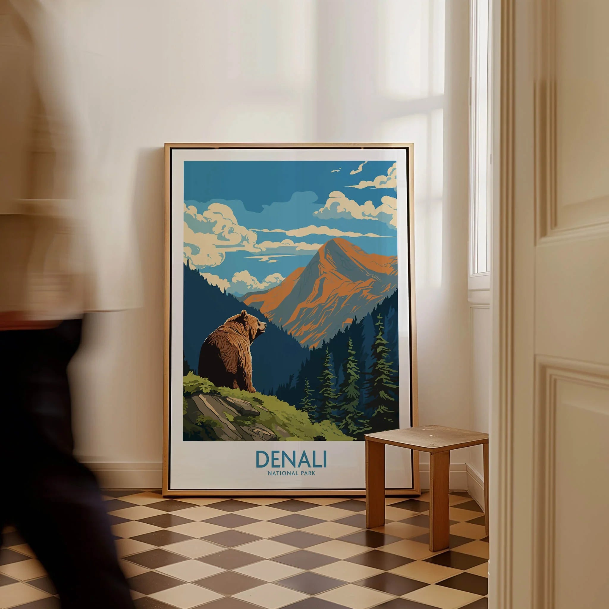 Framed Denali National Park travel poster with bear and mountains, resting on floor