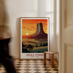 Framed Devils Tower National Monument travel poster on floor in sunlit modern hallway