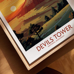 Framed Devils Tower National Monument travel poster with sunset landscape and trees