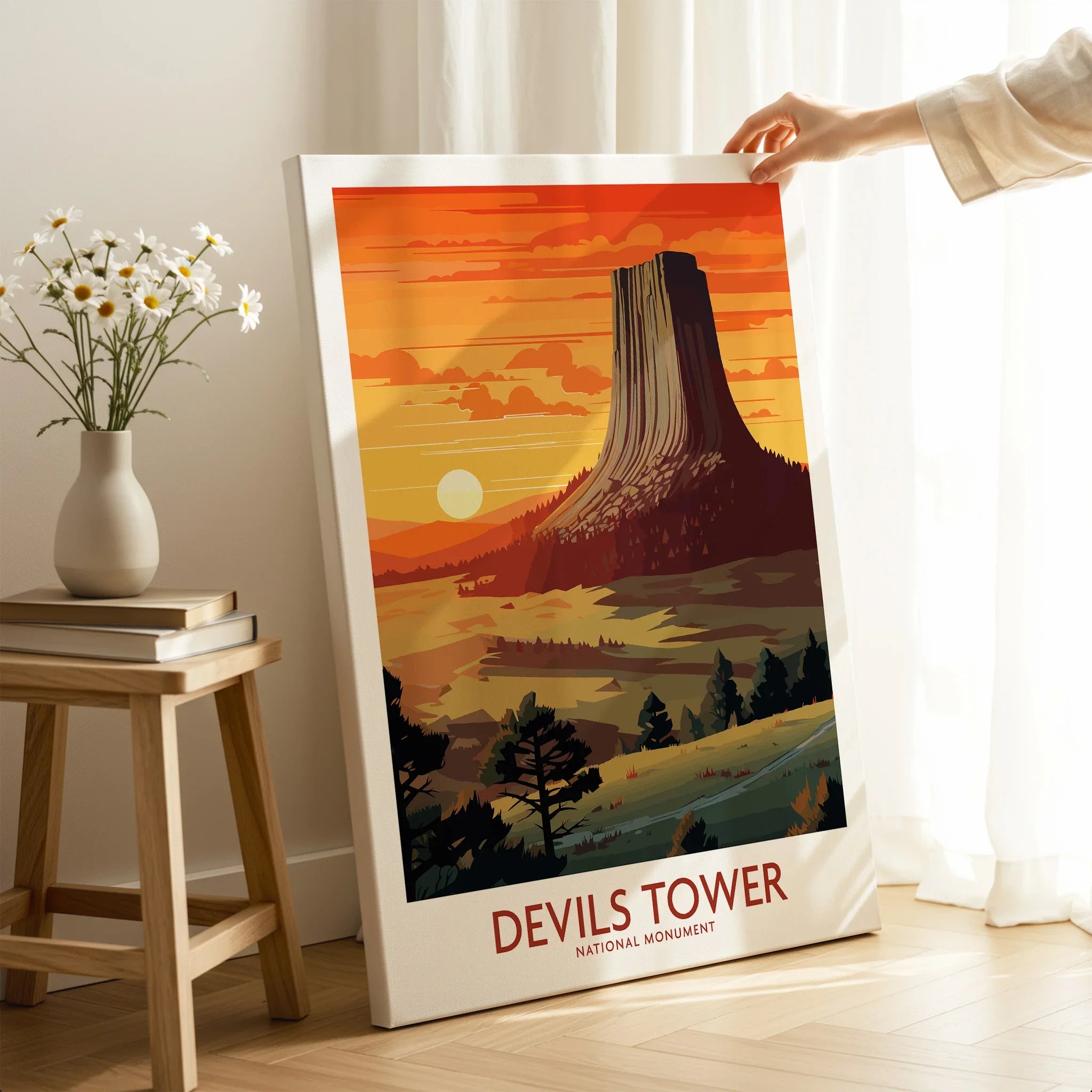 Devils Tower National Monument canvas wall art with hand holding in sunlit room