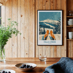 Falls Creek Ski Poster showcasing vibrant ski gear and a snowy mountain backdrop in a cozy home setting.