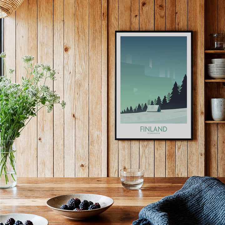 Finland Print Travel Poster displayed in a rustic setting with wooden walls and furniture, showcasing Nordic landscapes.