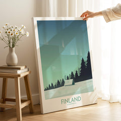 Finland Print Travel Poster showcasing minimalist design with northern lights and pine trees in a modern space.