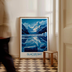 Framed Glacier Bay National Park travel poster on floor with man walking past in hallway