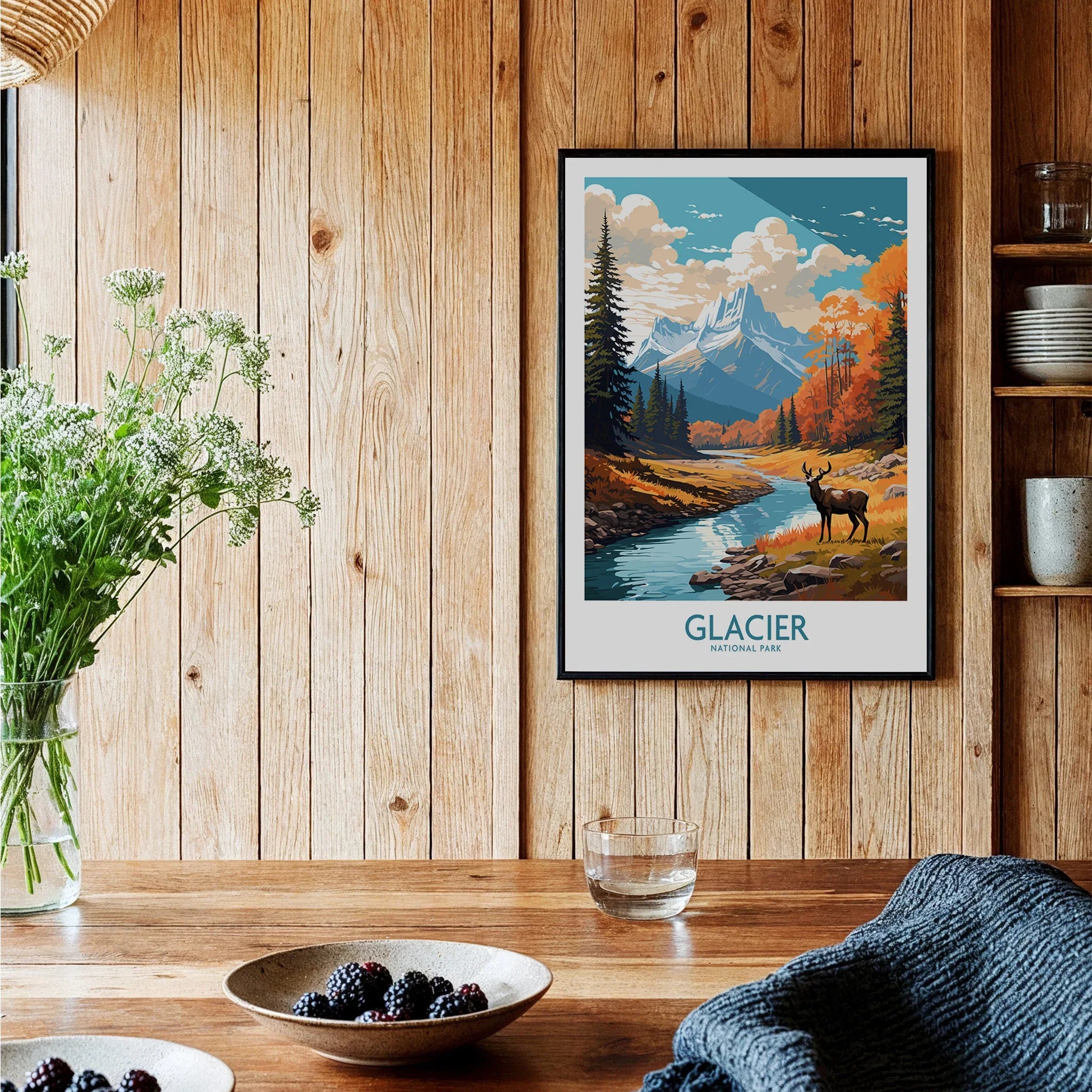 Glacier National Park art print with deer and mountains in a cozy kitchen with wood walls.