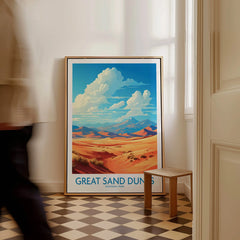 Framed Great Sand Dunes National Park travel poster in bright hallway, man walking past.