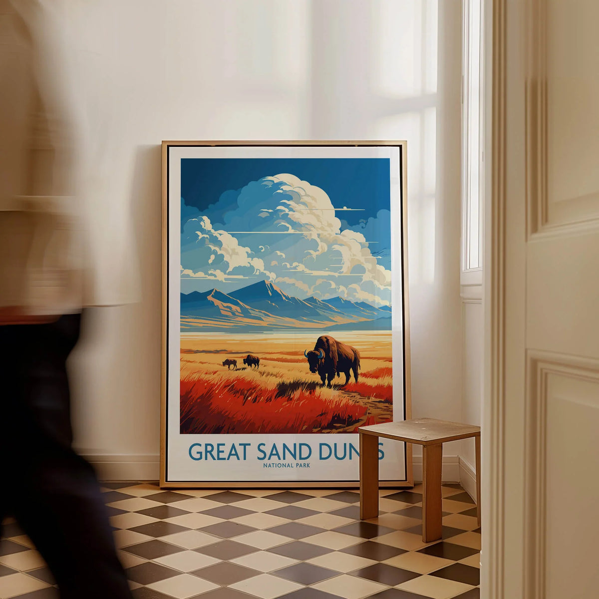Framed Great Sand Dunes National Park poster with bison, leaning on a wall in modern home