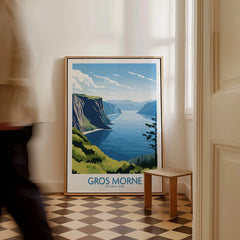 Framed Gros Morne National Park travel poster with lake and cliffs, leaning on floor.
