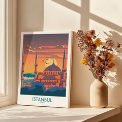 Istanbul Turkey travel poster with mosque skyline, sunset, and birds, displayed on windowsill with dried flowers.