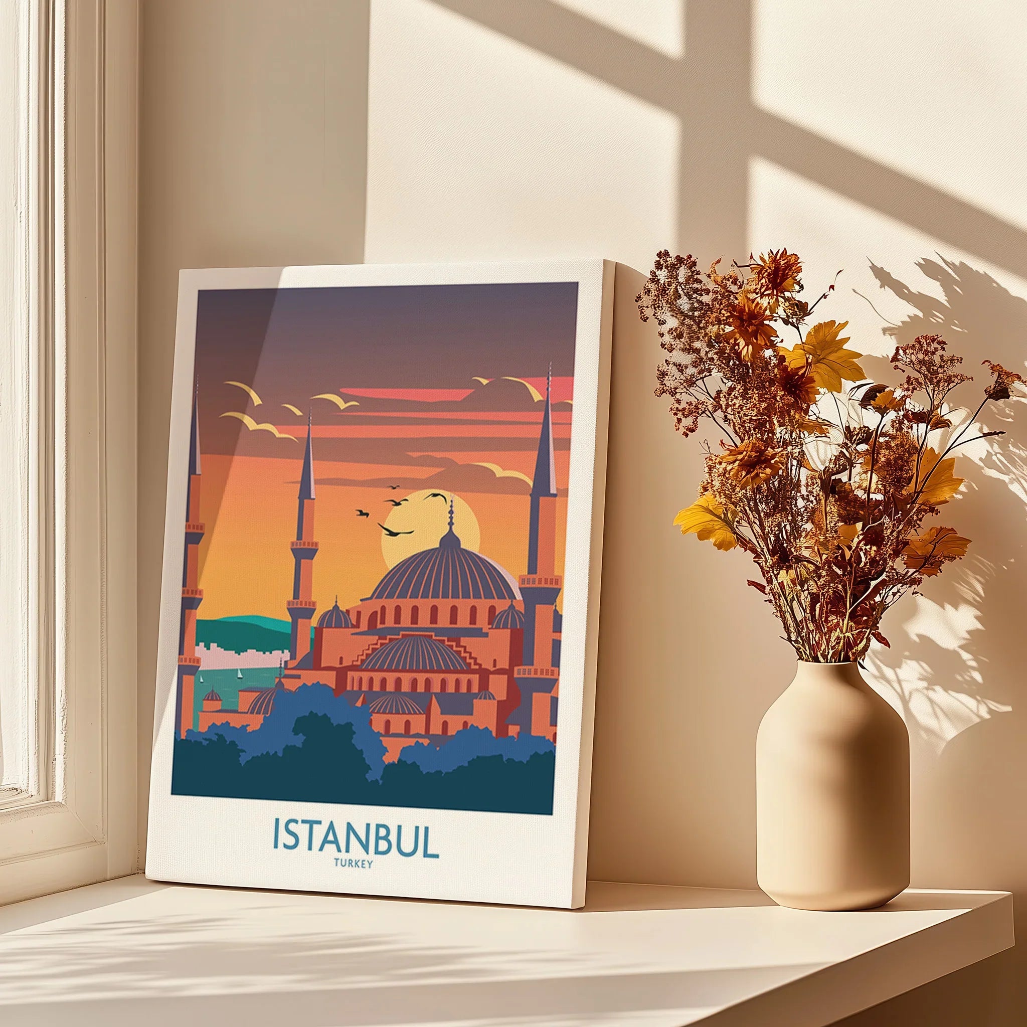 Istanbul Turkey travel poster with mosque skyline, sunset, and birds, displayed on windowsill with dried flowers.