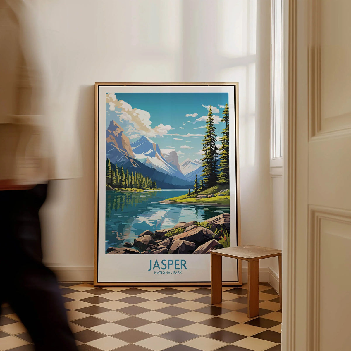 Framed Jasper National Park travel poster with lake and mountains on floor in modern home