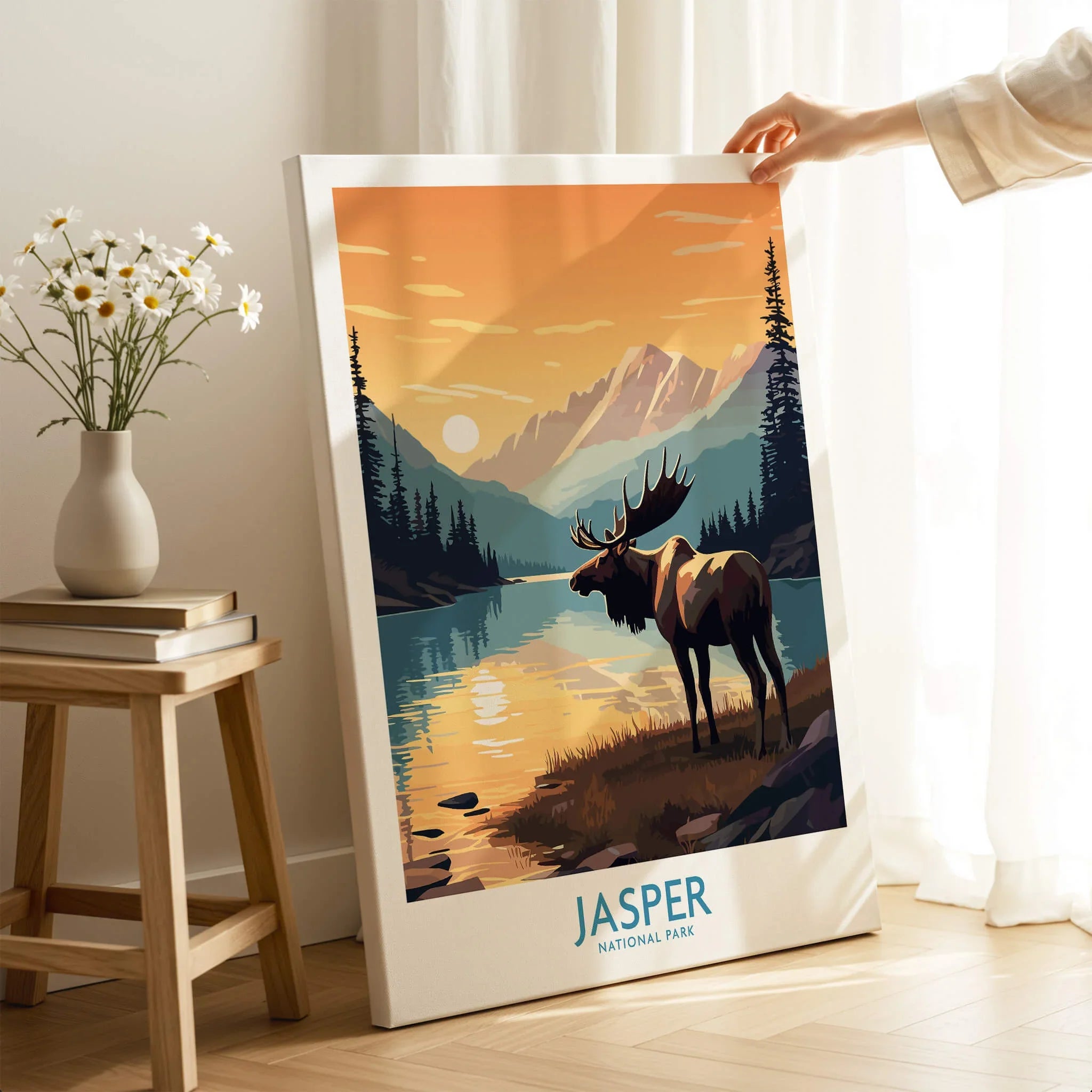 Jasper National Park wall art print with moose in sunset landscape, hand holding canvas in cozy room