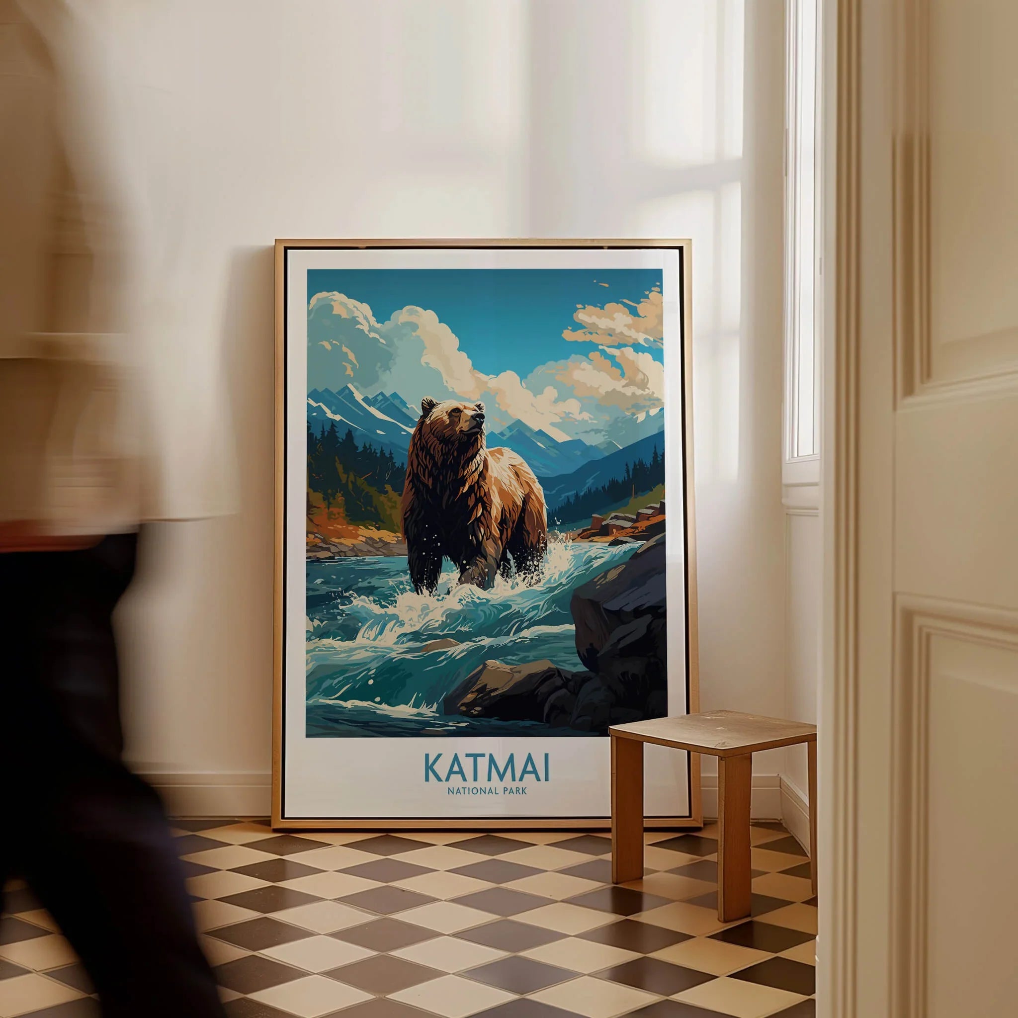 Framed Katmai National Park bear art print on floor, man walking past in modern home interior.
