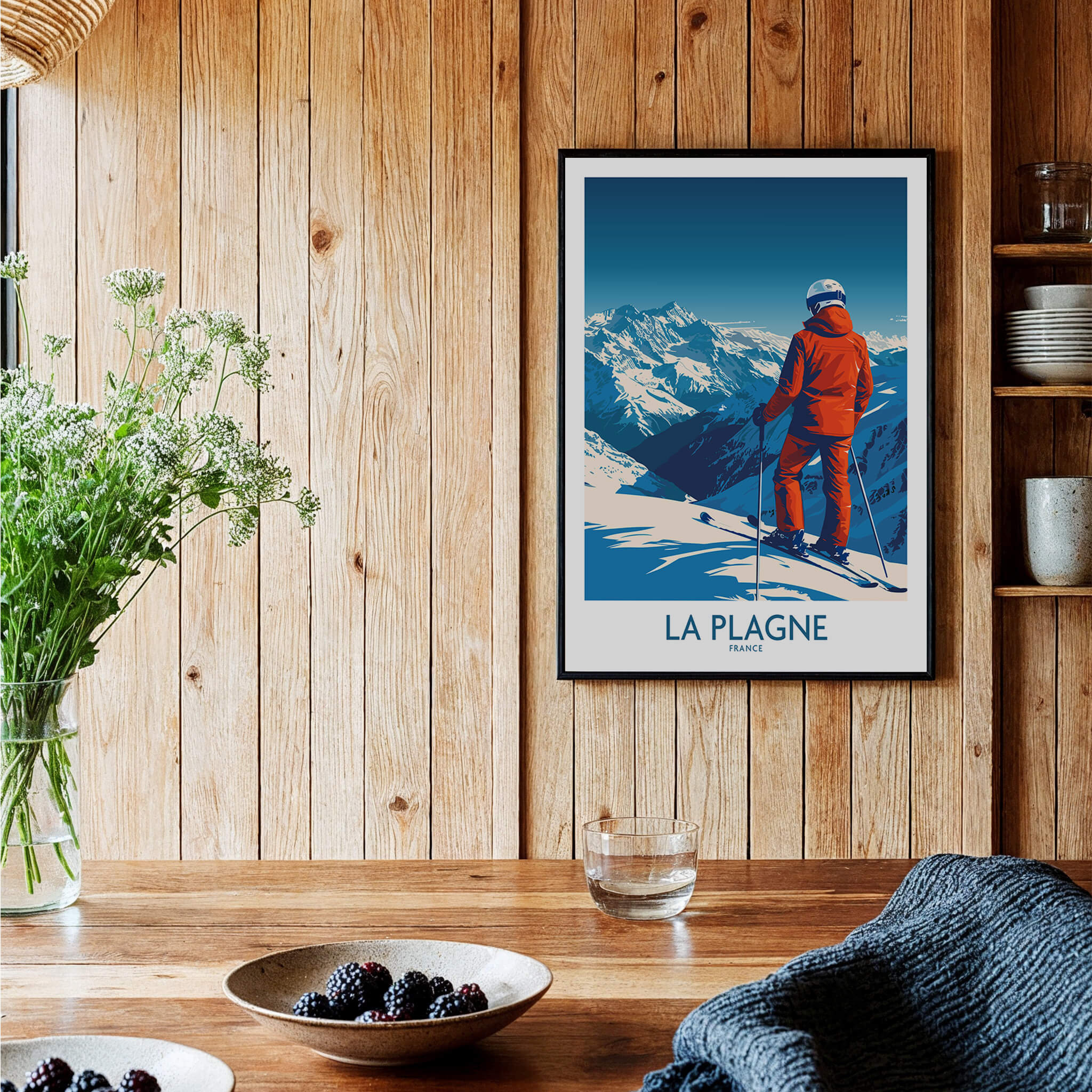 La Plagne Print ski poster featuring a skier overlooking the French Alps in a cozy interior setting.