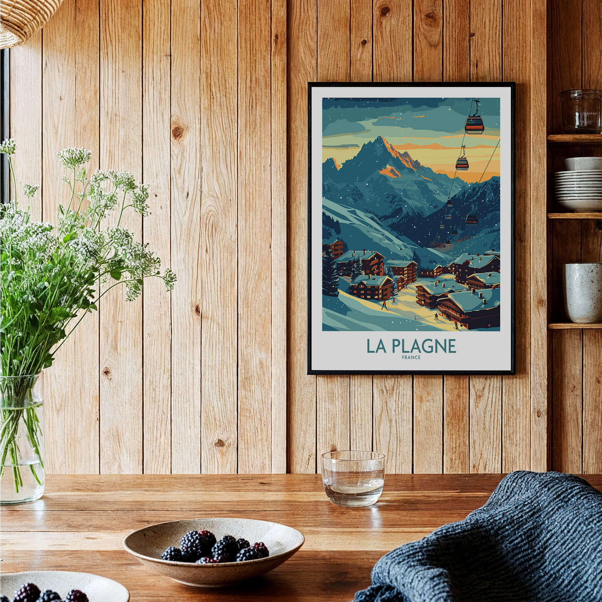 La Plagne Poster France displayed in a cozy interior with wooden walls and beautiful mountain scenery.