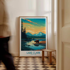 Framed Lake Clark National Park wall art with bear and mountain design on floor, man walking past