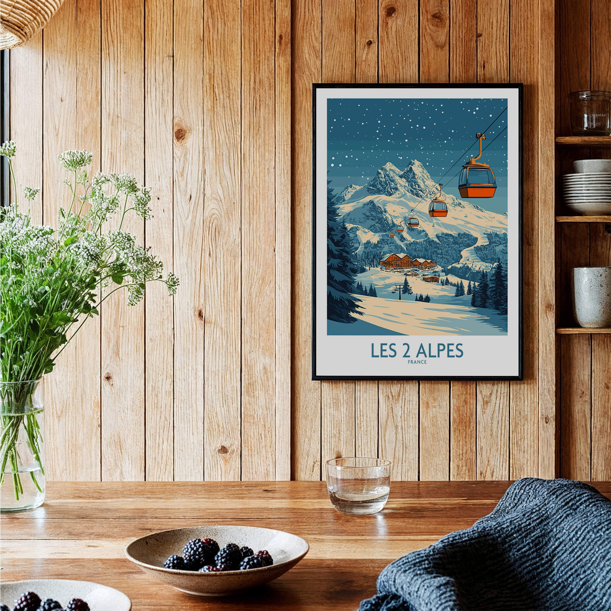 Les 2 Alpes Ski Poster displayed in a cozy setting with wooden decor and a bowl of berries.