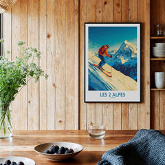 Les 2 Alpes Wall Art Ski Poster displayed in a cozy interior setting, showcasing skiing and beautiful mountain scenery.