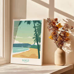 Maui Print Hawaii Poster on a table with palm trees, a sunset beach scene, and a flower vase in a bright room.