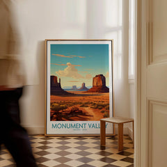 Framed Monument Valley travel poster with desert landscape on floor in sunlit room