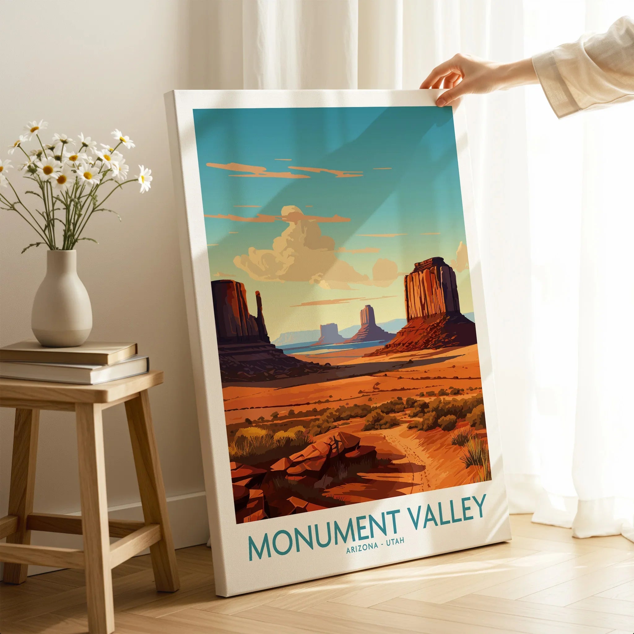 Monument Valley travel poster canvas print with desert landscape, hand holding it in a bright room