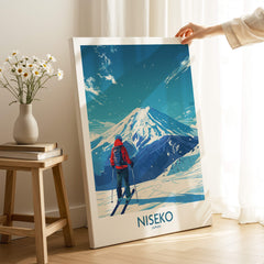 Niseko Ski Poster - Japan featuring a skier gazing at snow-covered mountains in a cozy setting.