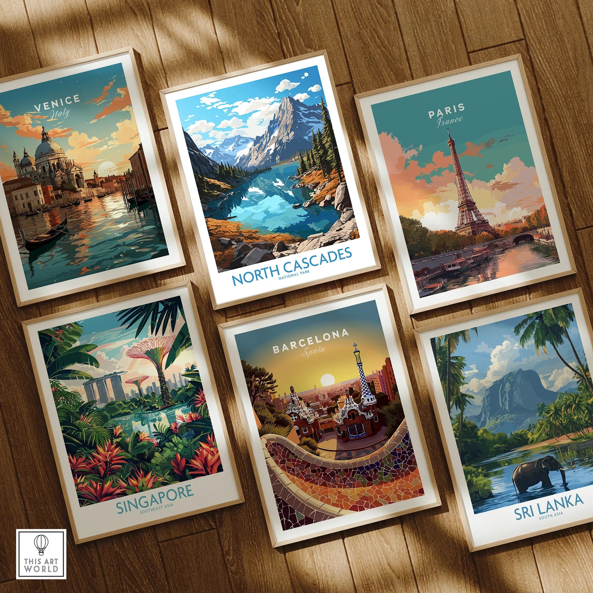 Set of six framed travel posters including Venice, North Cascades, Paris, Singapore, Barcelona, and Sri Lanka on wooden floor.