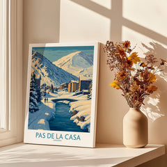 Pas de la Casa Andorra Art Print | Winter Village Bridge Poster displayed by a sunlit window with dried flowers.