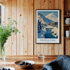 Pas de la Casa Andorra Art Print | Winter Village Bridge Poster displayed in a cozy interior with wooden walls.