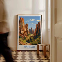 Framed Pinnacles National Park wall art print on floor in bright hallway, person walking past